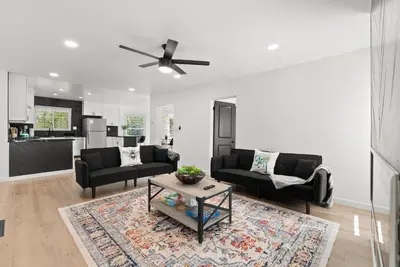 a living room with two couches and a table at Safari Vines Retreat in Escondido