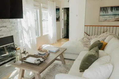 a living room with a white couch and a fireplace at Stylish PB Townhome, Walk to Bay, and Balcony in San Diego