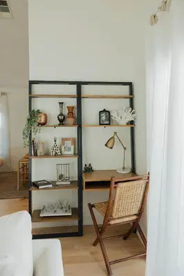 a room with a chair and a book shelf at Stylish PB Townhome, Walk to Bay, and Balcony in San Diego