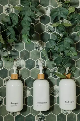 three bottles of soap sitting on a bathroom counter at Stylish PB Townhome, Walk to Bay, and Balcony in San Diego