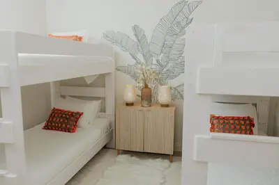 a room with a bunk bed with a couch and a table at Stylish PB Townhome, Walk to Bay, and Balcony in San Diego