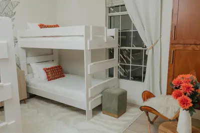 a room with two bunk beds and a chair at Stylish PB Townhome, Walk to Bay, and Balcony in San Diego