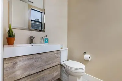 a bathroom with a white toilet and a sink at Bright Designer Oasis - Block from Bay - Roof Deck in San Diego