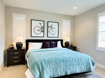 a bedroom with a bed with two framed bikes on the wall at Close to UCI 4b&4b villa Irvine eastwood in Irvine