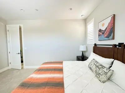 a bedroom with a large bed with a wooden headboard at Close to UCI 4b&4b villa Irvine eastwood in Irvine