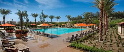 a swimming pool with chairs and umbrellas in a resort at Close to UCI 4b&4b villa Irvine eastwood in Irvine