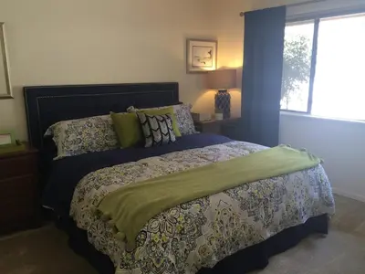 a bedroom with a bed with a comforter and a window at Quiet Retreat With Pool And Hot Tub in Escondido