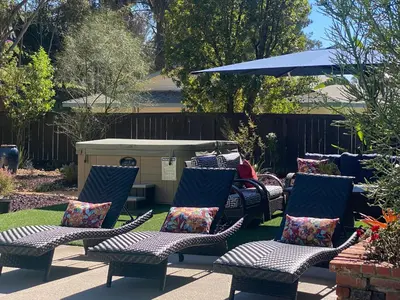 a group of chairs and an umbrella in a yard at Quiet Retreat With Pool And Hot Tub in Escondido