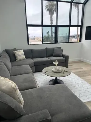 a living room with a couch and a table at La Jolla Townhouse steps away from Windansea beach in San Diego
