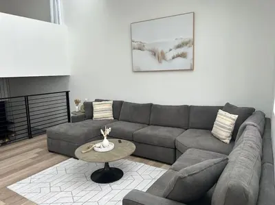 a living room with a couch and a table at La Jolla Townhouse steps away from Windansea beach in San Diego