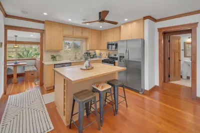 a kitchen with a large island with bar stools at Near All Things SD - Canyonview - Jacuzzi - EV Charge in San Diego