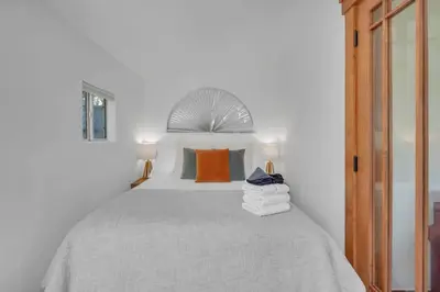 a bedroom with a large bed with two lamps at Near All Things SD - Canyonview - Jacuzzi - EV Charge in San Diego