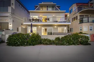 a large white house with a balcony in front of it at Life's A Beach 2 in San Diego