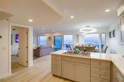 a kitchen and living room with a view of the ocean at Life's A Beach 2 in San Diego