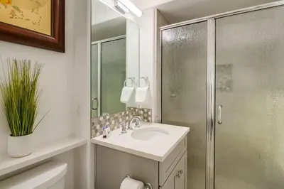a white bathroom with a shower and a sink at Life's A Beach 2 in San Diego