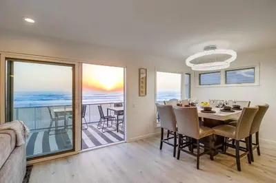 a dining room with a table and views of the ocean at Life's A Beach 2 in San Diego