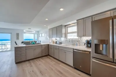 a kitchen with wooden floors and stainless steel appliances at Life's A Beach 2 in San Diego