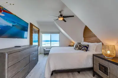 a bedroom with a large bed and a ceiling fan at Life's A Beach 2 in San Diego