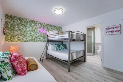 a bedroom with a bunk bed and a bathroom at Life's A Beach 2 in San Diego