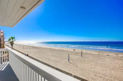 a view of the beach from the balcony of a house at Rip Tide in San Diego