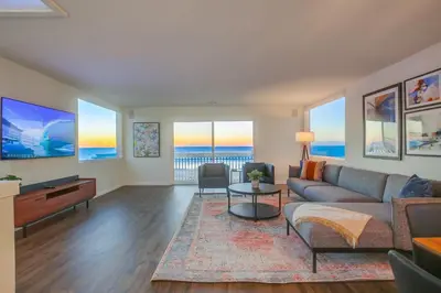 a living room with a couch and a table at Rip Tide in San Diego