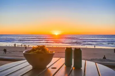 a table with a bowl of food on the beach at Salt Life in San Diego