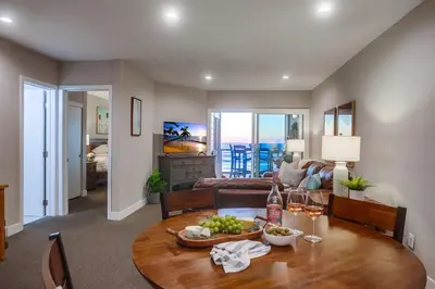 a living room with a table with a bowl of fruit at Salt Life in San Diego