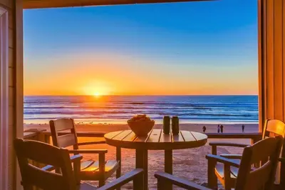 a room with a table and a view of the beach at Salt Life in San Diego