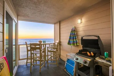 a kitchen with a table and a stove and a view of the ocean at Salt Life in San Diego