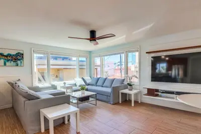 a living room with a couch and a flat screen tv at Sky High in San Diego