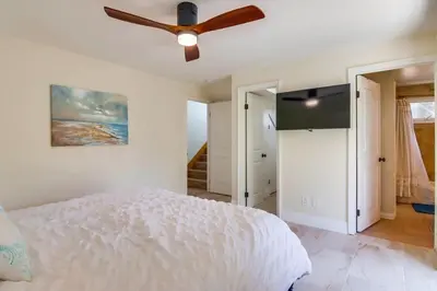 a bedroom with a bed and a ceiling fan at Sky High in San Diego