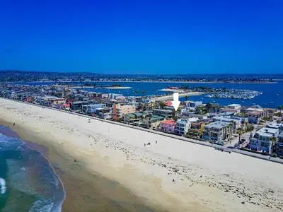 an aerial view of a beach with buildings and the ocean at Sky High in San Diego