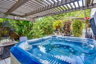a blue tub in a yard with plants at Costa Mesa Rental with Private Hot Tub and Fire Pit! in Costa Mesa