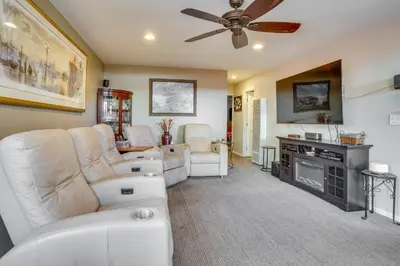 a living room with white furniture and a ceiling fan at Costa Mesa Rental with Private Hot Tub and Fire Pit! in Costa Mesa