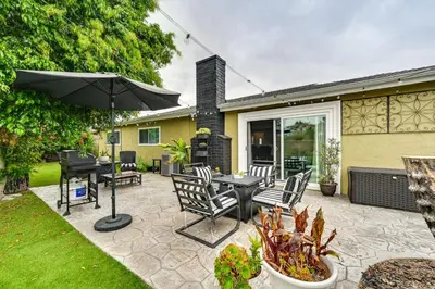 a patio with a table and chairs and an umbrella at San Diego Family Home with Lush Backyard Patio! in San Diego