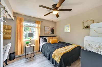 a bedroom with a bed and a ceiling fan at San Diego Family Home with Lush Backyard Patio! in San Diego