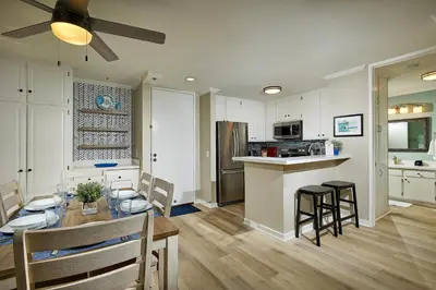 a kitchen and dining room with a table and chairs at Oceanside Beach Condos in Oceanside