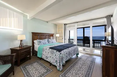 a bedroom with a bed with a view of the ocean at Beachfront Retreat in Oceanside
