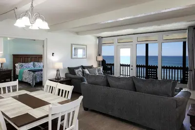a living room with a couch and a table at Beachfront Retreat in Oceanside