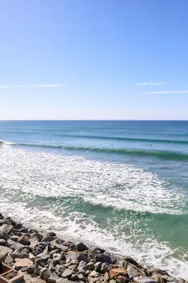 a rocky beach with the ocean in the background at Beachfront Retreat in Oceanside