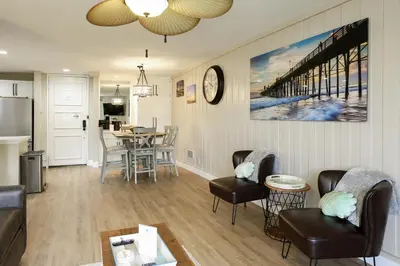 a living room with a couch and chairs and a table at Oceanside Beach Condos in Oceanside