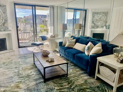 a living room with a blue couch and a table at Oceanside Beach Condos in Oceanside