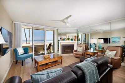 a living room with a couch and a fireplace at Oceanside Beach Condos in Oceanside