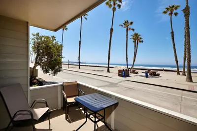 a balcony with a table and chairs and a view of the beach at Oceanside Beach Condos in Oceanside