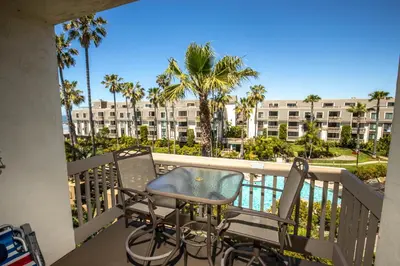 a balcony with a table and chairs and a view of a building at Oceanside Beach Condos in Oceanside