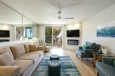 a living room with a couch and a table at Oceanside Beach Condos in Oceanside