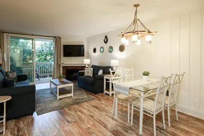 a living room with a table and a dining room at Oceanside Beach Condos in Oceanside