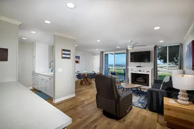 a kitchen and living room with a table and chairs at Oceanside Beach Condos in Oceanside