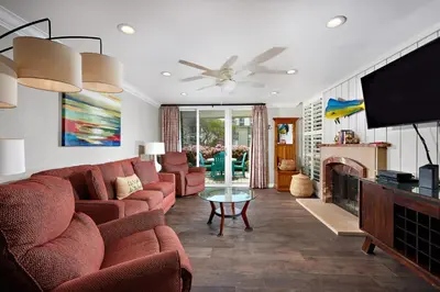 a living room with a couch and a tv at Oceanside Beach Condos in Oceanside
