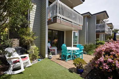 a patio with chairs and a table on a deck at Oceanside Beach Condos in Oceanside